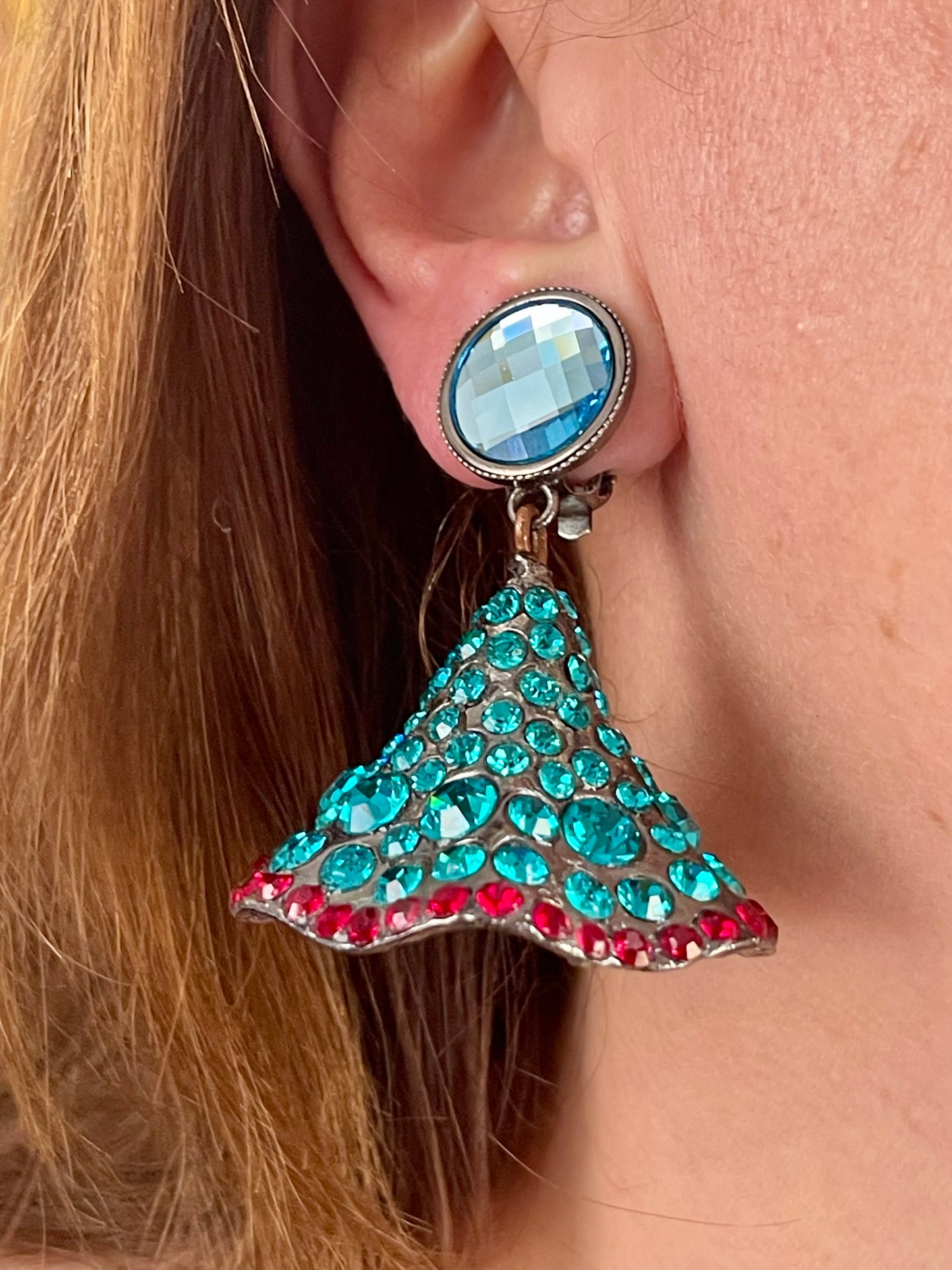 Close-up of Yves Saint Laurent Rive Gauche vintage statement earrings with turquoise and red rhinestones worn by model right side 