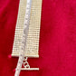 105cm length vintage silver Paco Rabanne mesh belt on red velvet background using a measuring tape 