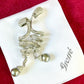 Grossé silver-tone drop earrings with rhinestones and grey pearl, displayed on branded box