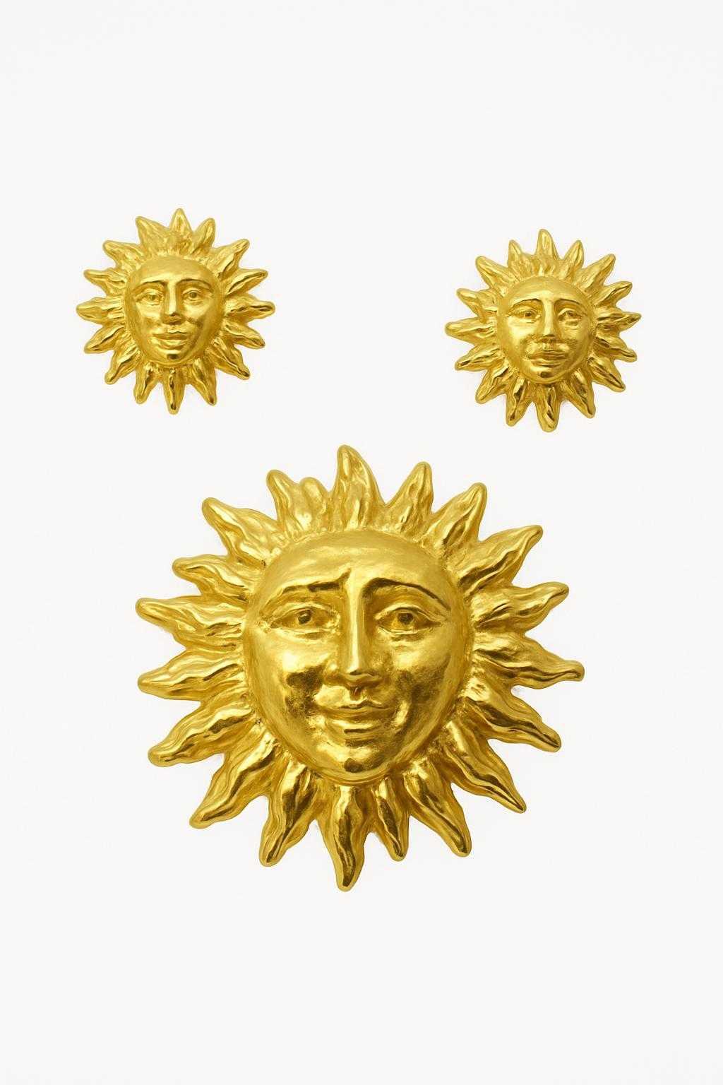 gold plated vintage sun jewellery set on white background 