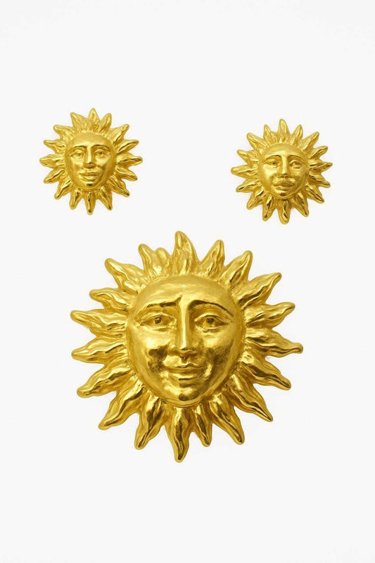gold plated vintage sun jewellery set on white background 