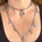 Worn by model two upcycled Dior Beauté phone charm necklace with removable silver-tone charms