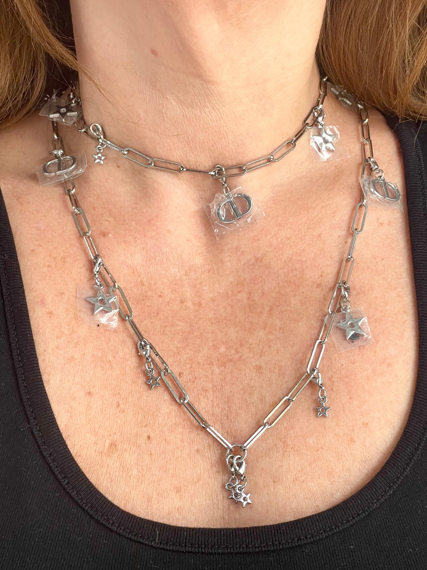 Worn by model two upcycled Dior Beauté phone charm necklace with removable silver-tone charms