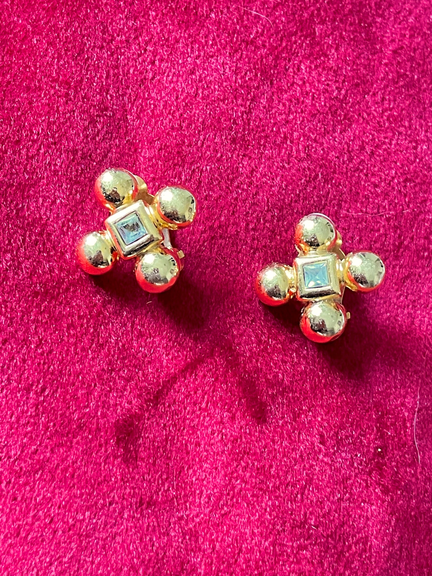 Yves Saint Laurent vintage gold tone cross clip-on earrings from the 1980s, showing rounded gold domes and square-cut center stones YSL collector Jewelry 