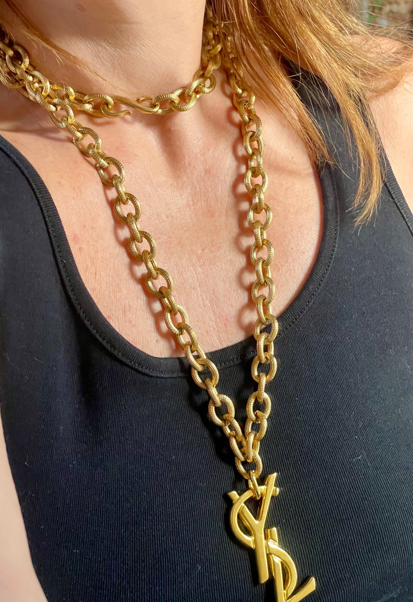 Worn by model Upcycled vintage Yves Saint Laurent gold-plated logo pendant on long stainless steel chain necklace showing different styles 