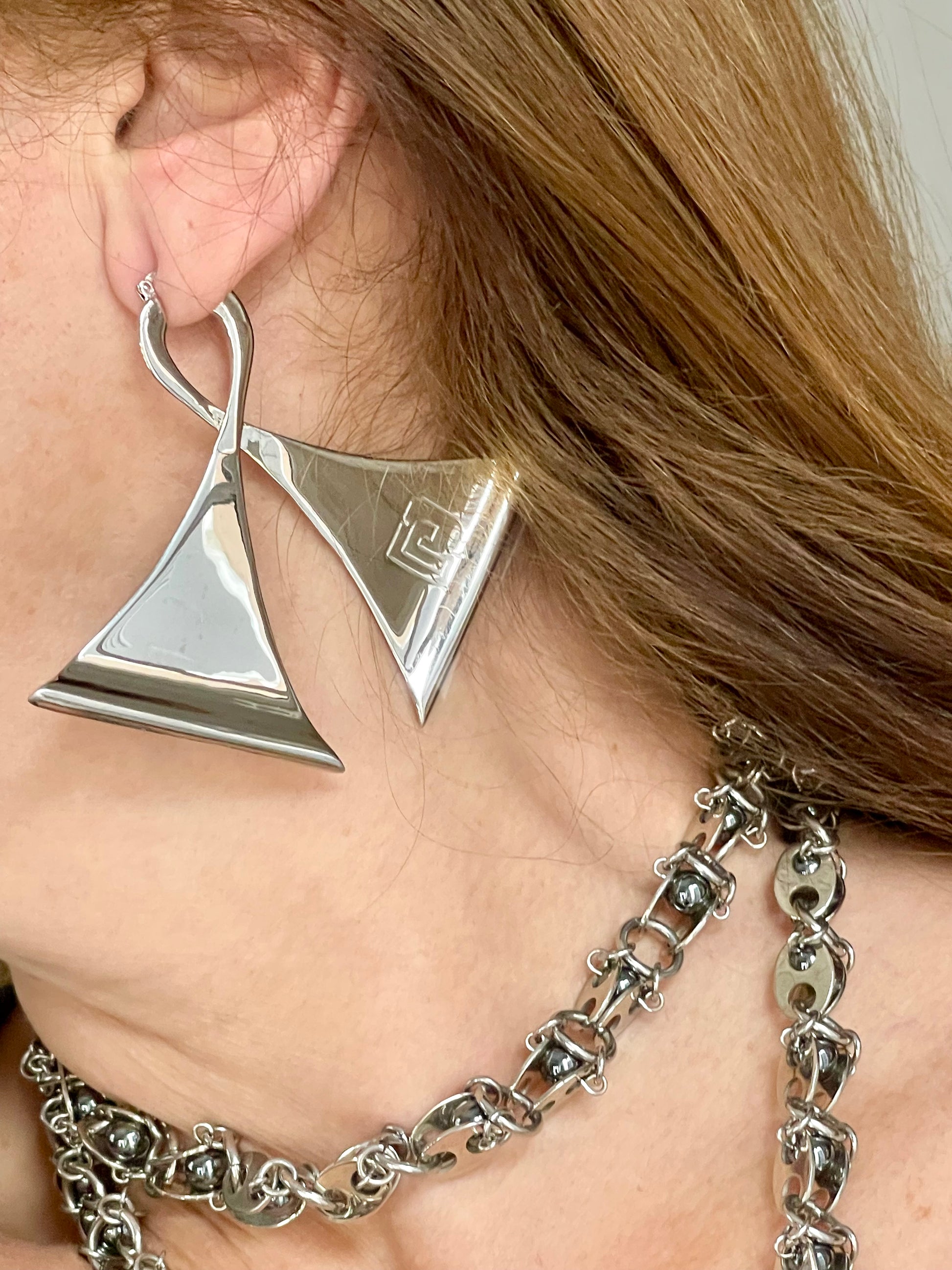 Left side worn by model Vintage Paco Rabanne silver-tone geometric sculptural statement earrings