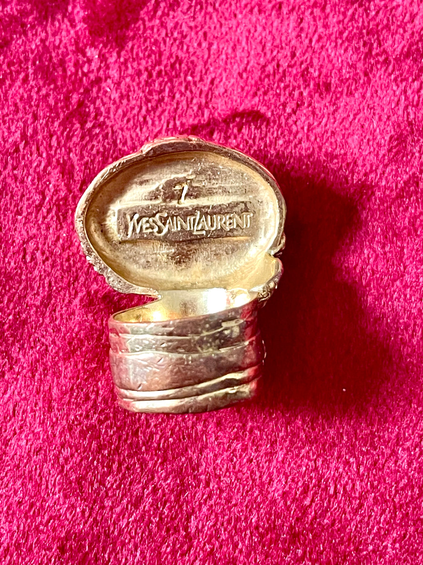 Back of a vintage Yves Saint Laurent ring, showing slight wear on the gold metal band, consistent with its vintage character. Authentic signed , size 7