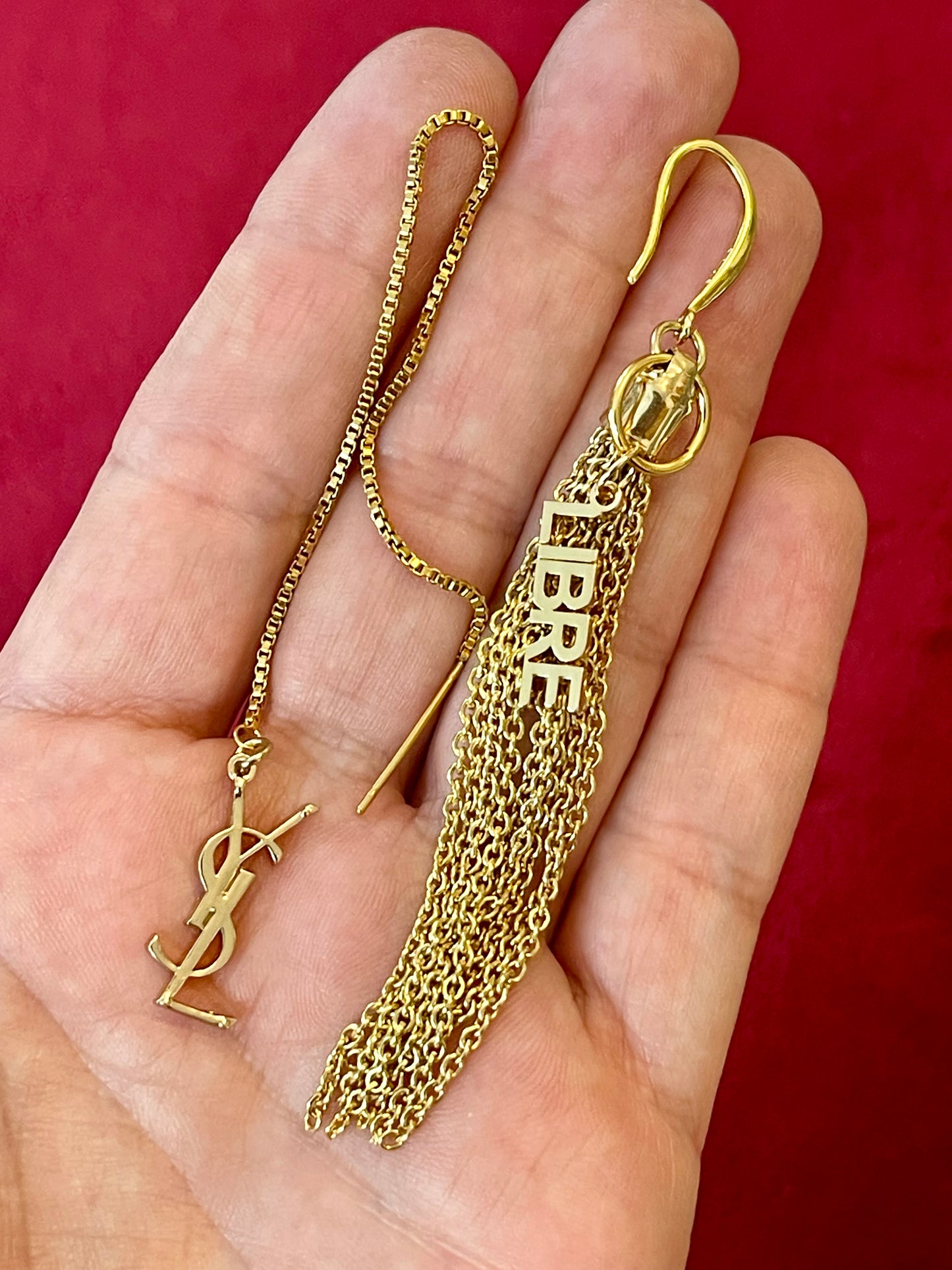 Gold tassel earring repurposed with chain and Yves Saint Laurent Libre charms on hand 