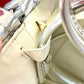 Showing signs of age of Paco Rabanne silver shoulder/wrist bag with both straps shown, on red velvet fabric background.