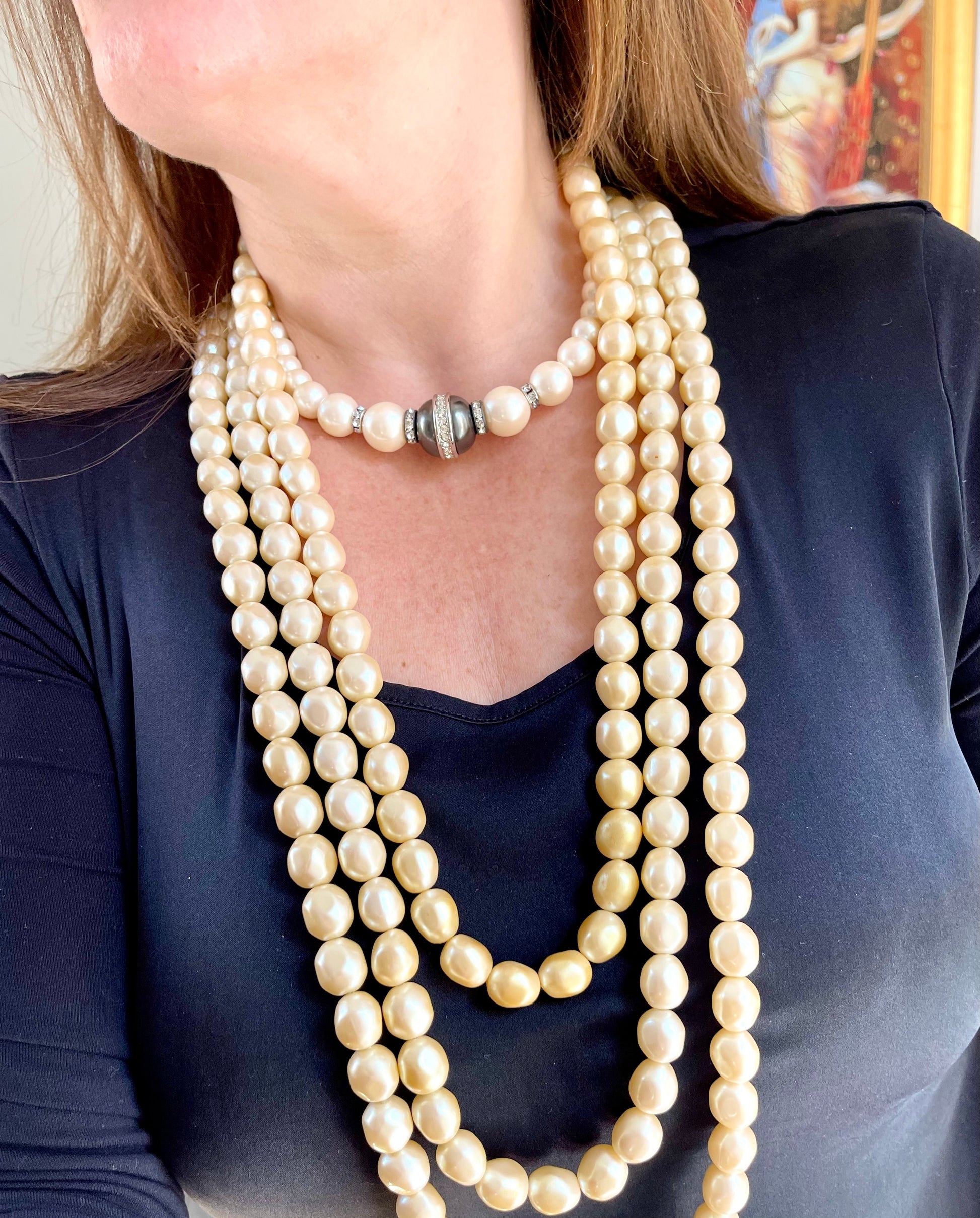 Vintage Yves Saint Laurent multi-strand pearl necklace layered with shorter pearls for a sophisticated, fashion-forward look.