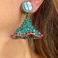 Close-up of Yves Saint Laurent Rive Gauche vintage statement earrings with turquoise and red rhinestones worn by model showing the imperfections 
