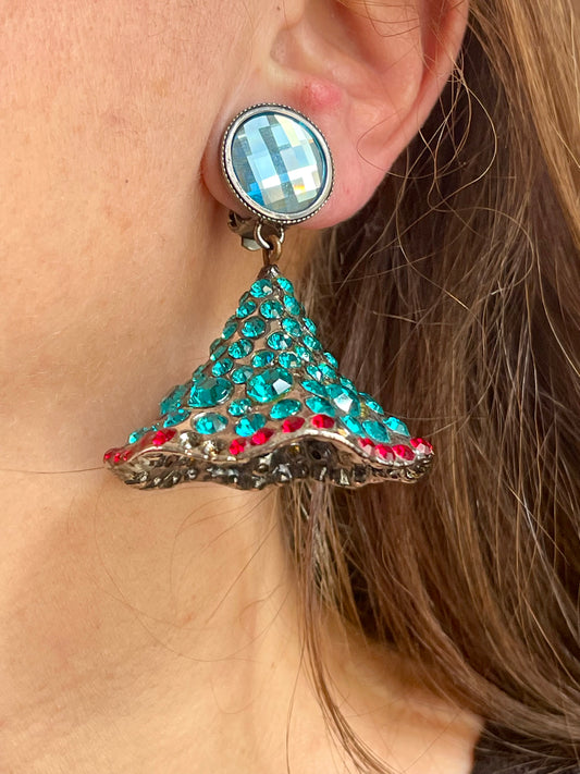 Close-up of Yves Saint Laurent Rive Gauche vintage statement earrings with turquoise and red rhinestones worn by model showing the imperfections 