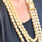 YSL vintage pearl necklace styled with classic outfit, adding elegant statement jewelry to a chic ensemble
