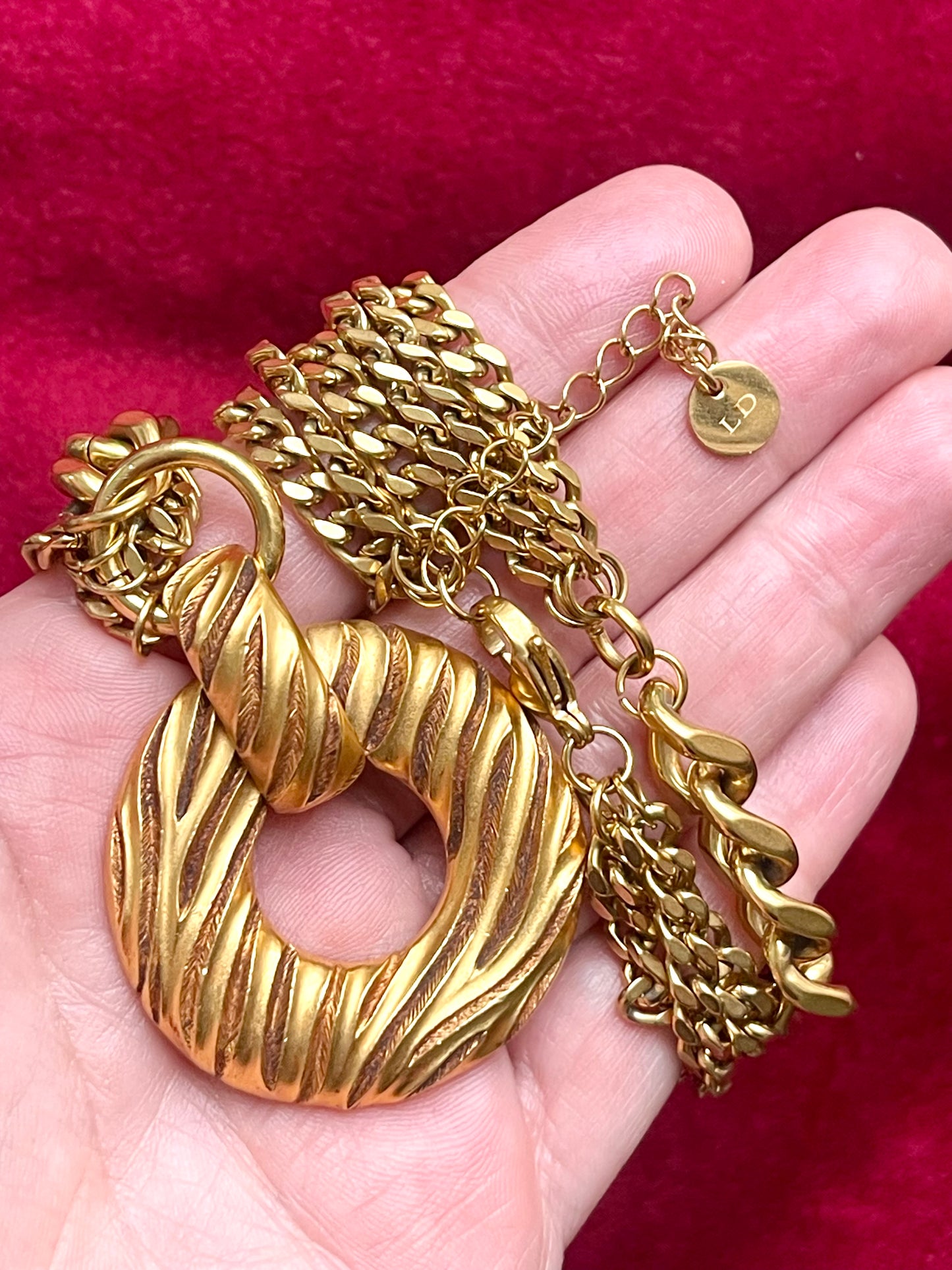 Yves Saint Laurent vintage gold tone rustic pendant stainless steel chain necklace held on hand