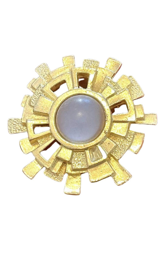 A vintage Paco Rabanne Paris brooch with a geometric design and a central milky cabochon stone, refurbished in 18K yellow gold.