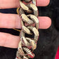 Close up Preloved YSL bronze and grey chain worn as a statement piece against black fabric and YSL pouch held by hand 