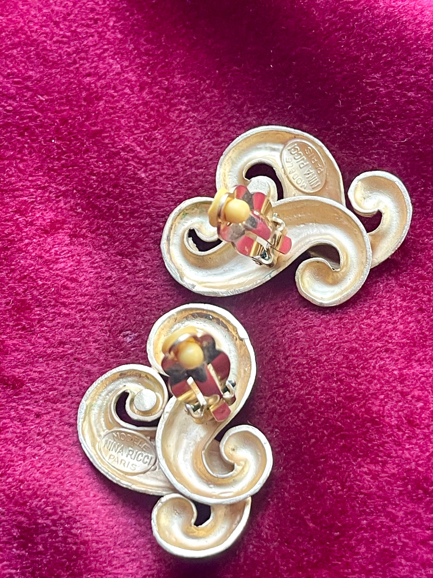 Back view of signed Nina Ricci Paris earrings in matte gold plated metal, minor signs of wear visible