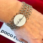 Paco Rabanne collectible mesh bracelet vintage jewelry Worn on wrist with a red background 