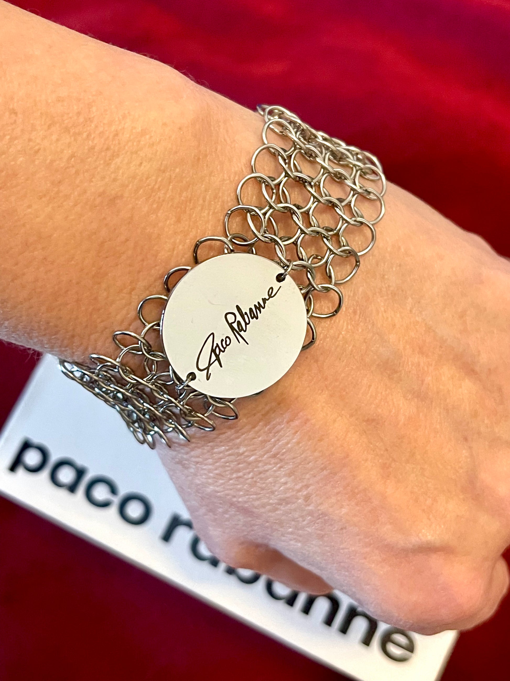 Paco Rabanne collectible mesh bracelet vintage jewelry Worn on wrist with a red background 