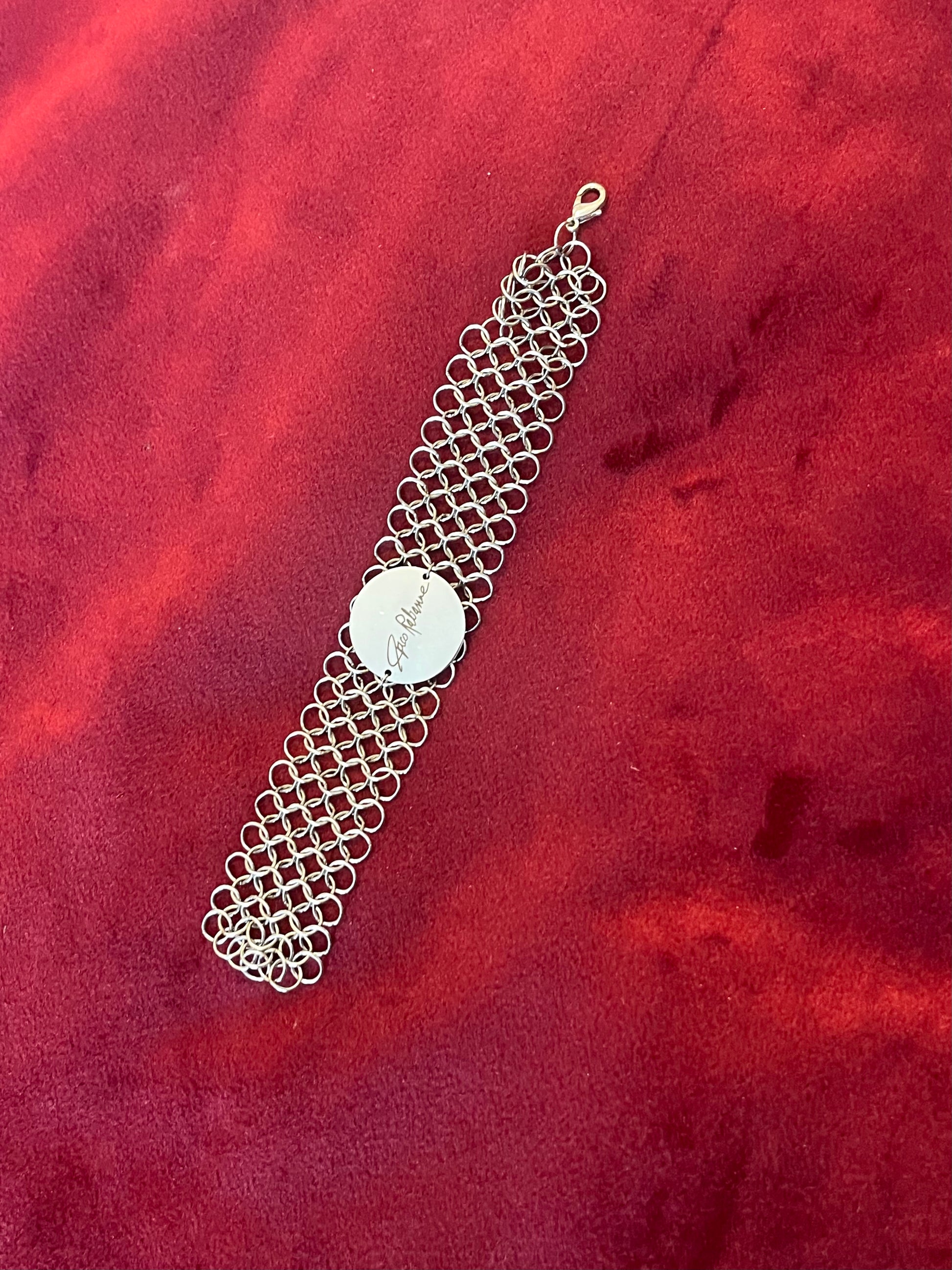 Paco Rabanne silver-tone chainmail bracelet full view On red background 