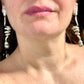 Grossé statement earrings worn, showcasing elegant drop design and pearl detail