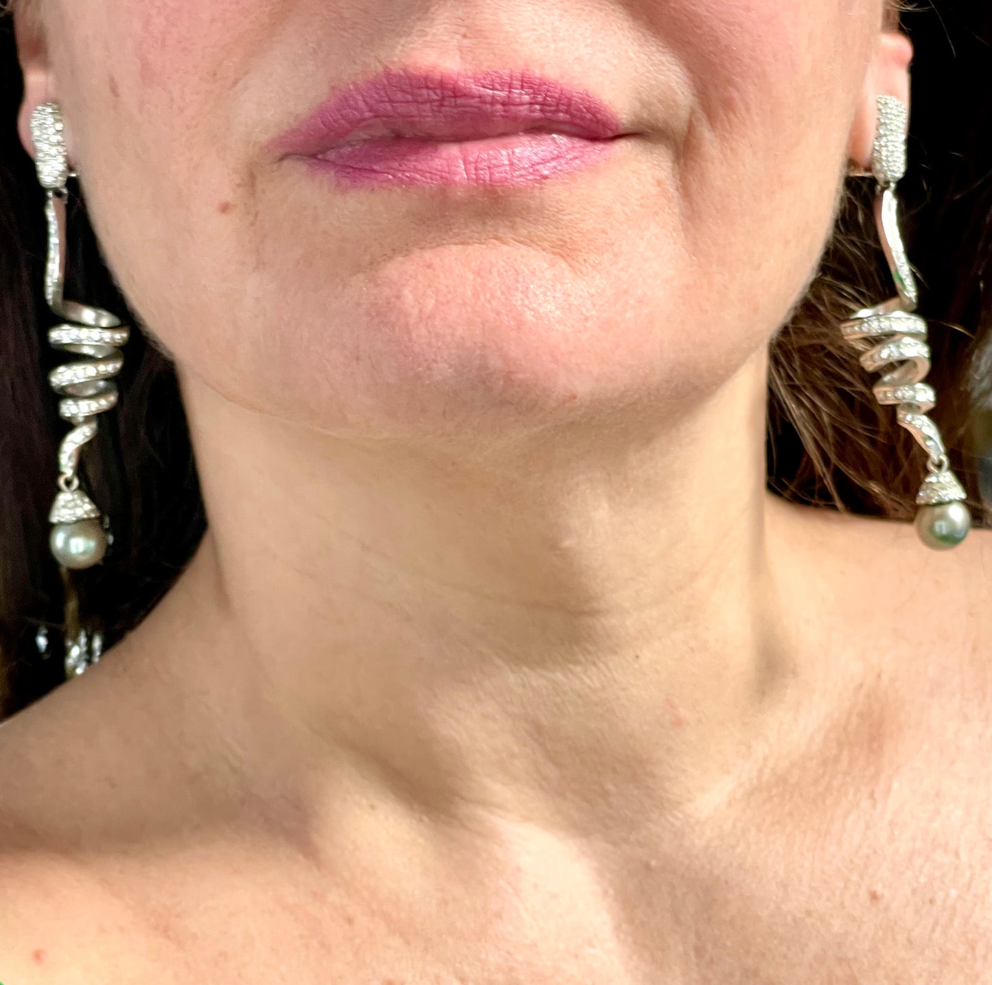Grossé statement earrings worn, showcasing elegant drop design and pearl detail