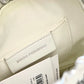 Signature view of Paco Rabanne silver shoulder/wrist bag with both straps shown, on red velvet fabric background.