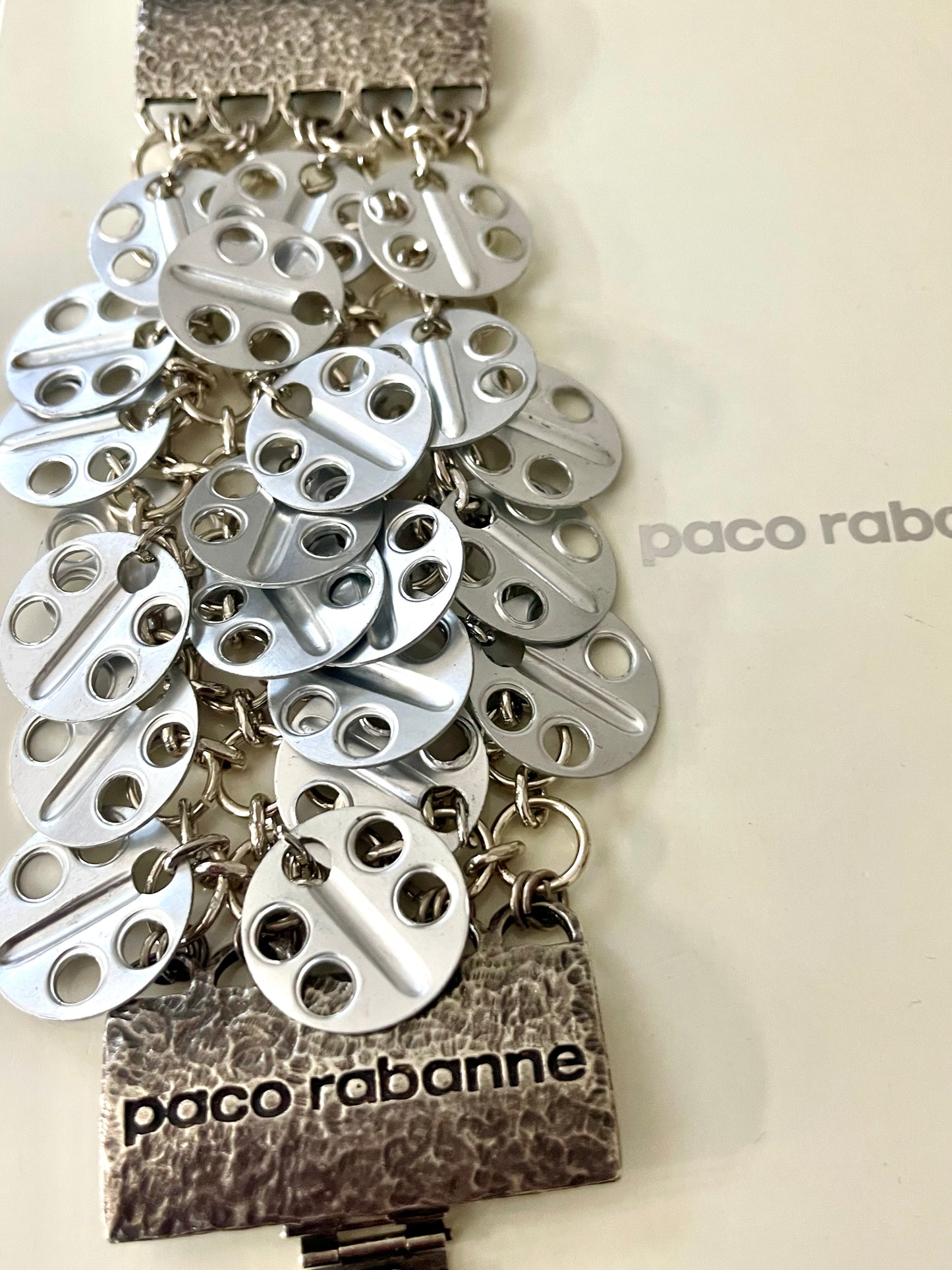 Vintage Paco Rabanne bracelet cascading disc design On white background 
