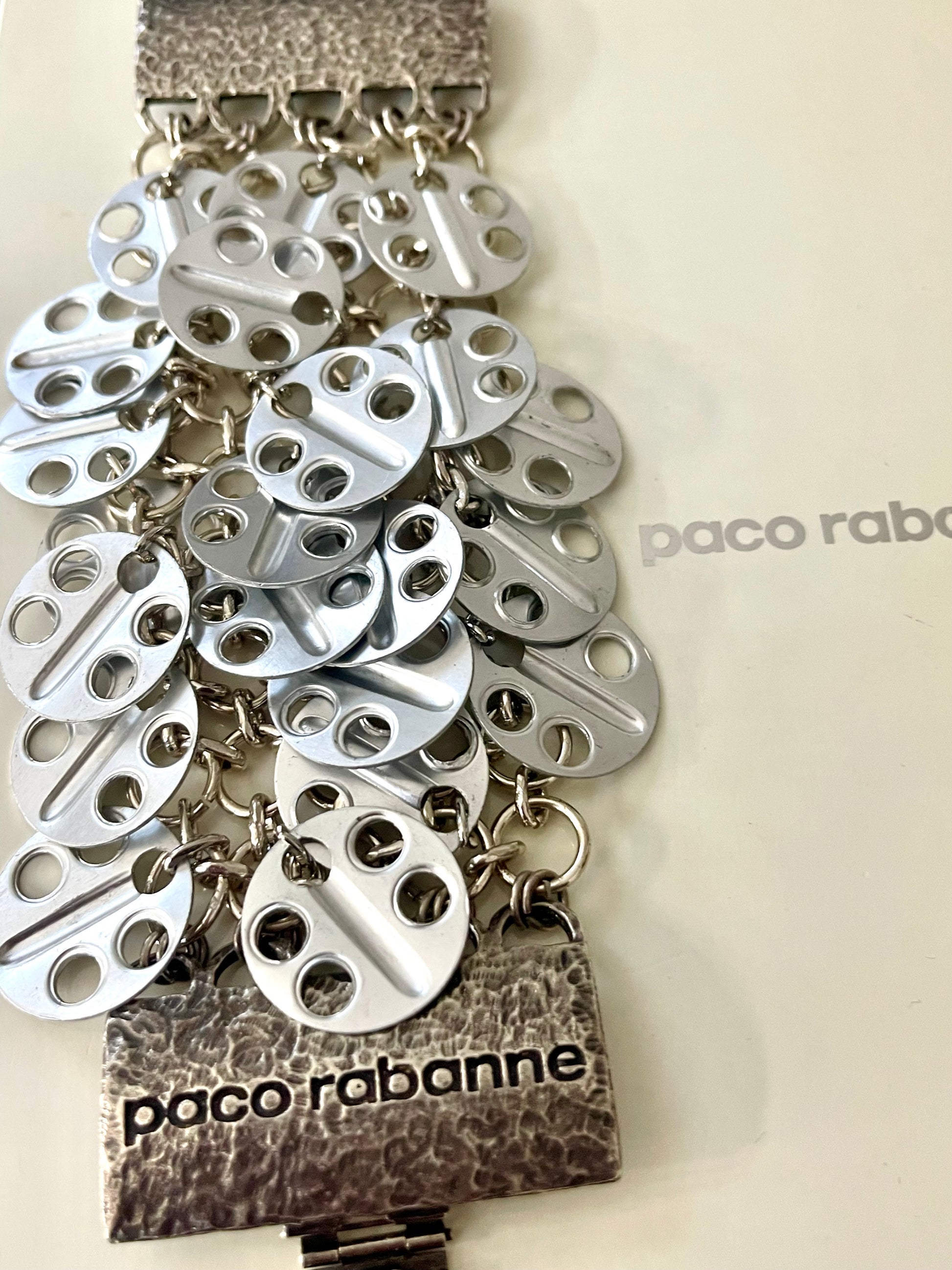 Vintage Paco Rabanne bracelet cascading disc design On white background 