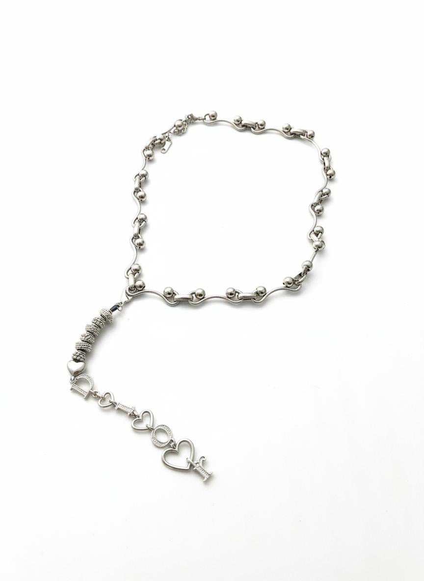 Authentic Dior phone charm upcycled into a silver-tone convertible pendant necklace, shown on white background