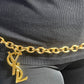 Large Yves Saint Laurent YSL logo pendant from vintage bag charm, styled as long belt.