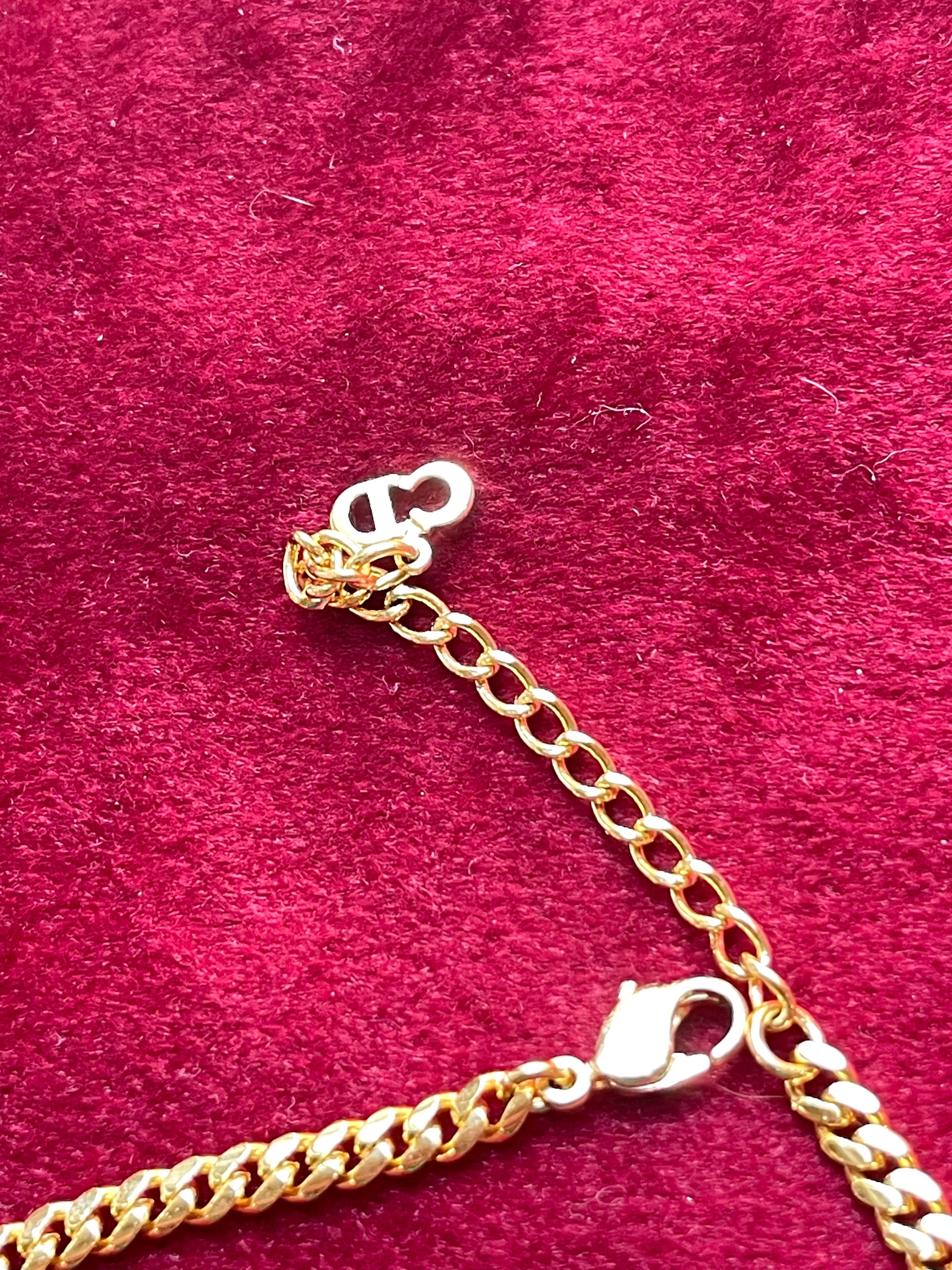 Close-up of Christian Dior CD logo charm on vintage 18K gold-plated necklace