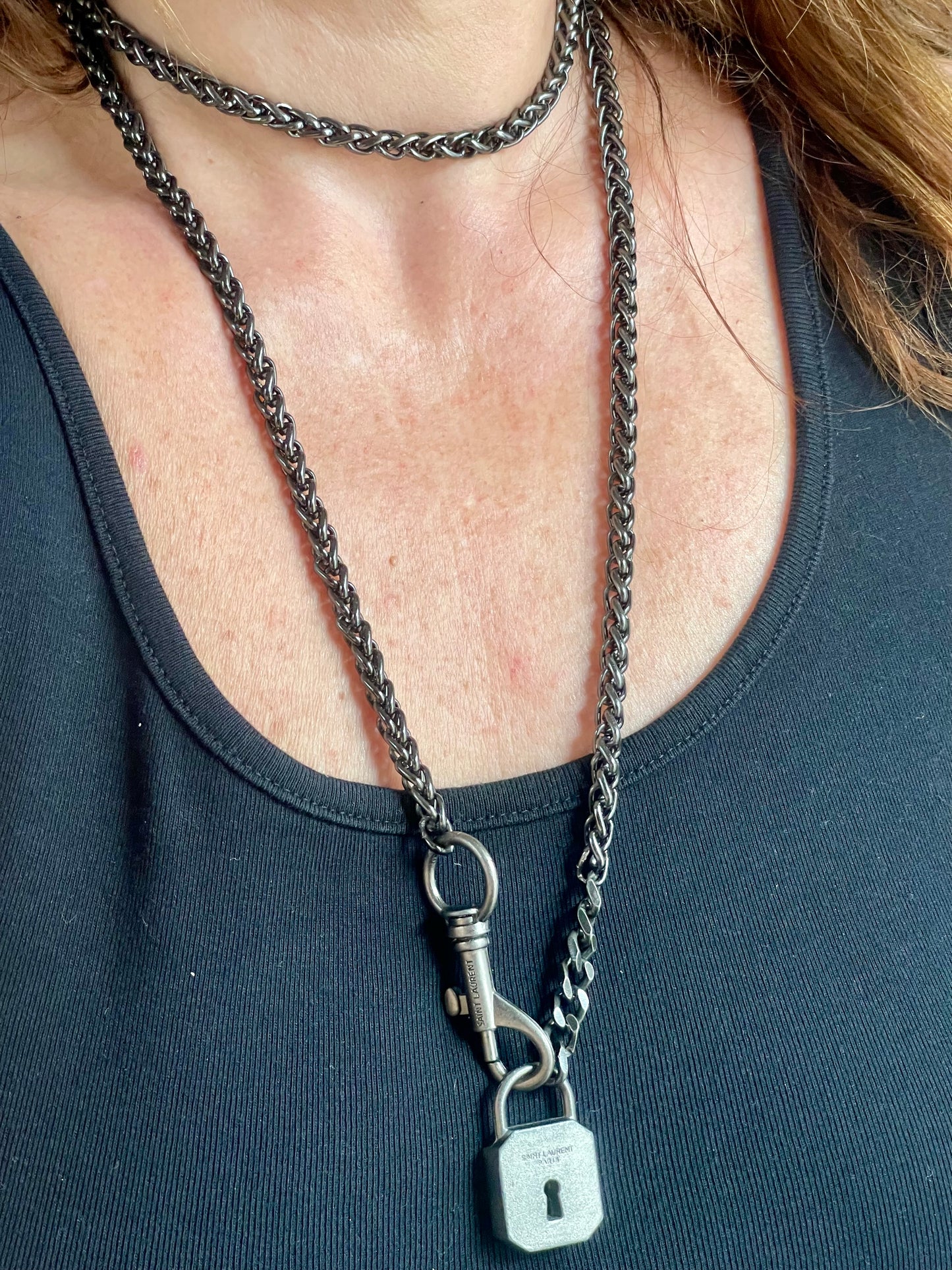 Worn by model close up on Vintage Saint Laurent upcycled necklace featuring a dark gunmetal chain with original lock and key charm pendant, repurposed from a Saint Laurent keychain In a different style 
