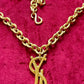 Authentic YSL oversized gold logo bag charm pendant repurposed into a long chain necklace, close-up detail