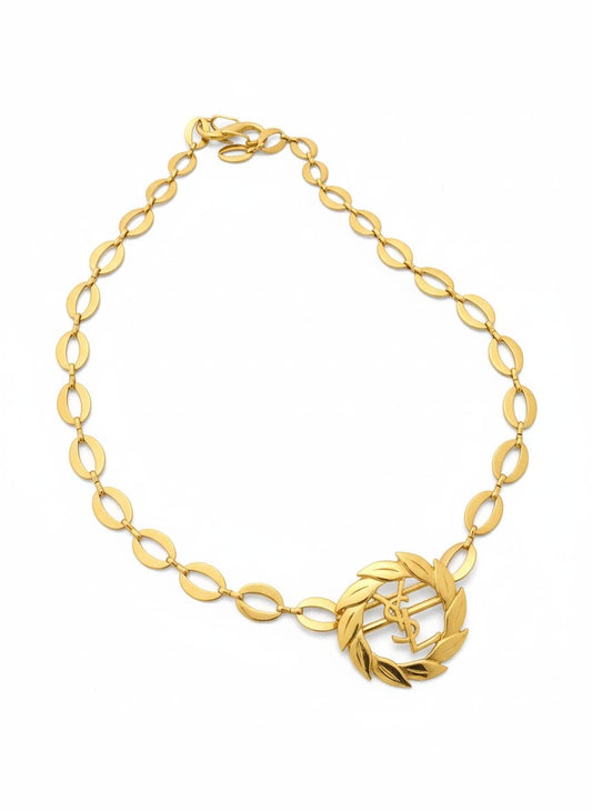 Top view of a refurbished vintage YSL laurel wreath pendant mounted on a gold-plated stainless steel necklace, with adjustable hoop links and a slightly lighter-toned closure.