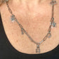 Worn by model on single upcycled Dior Beauté phone charm necklace with removable silver-tone charms