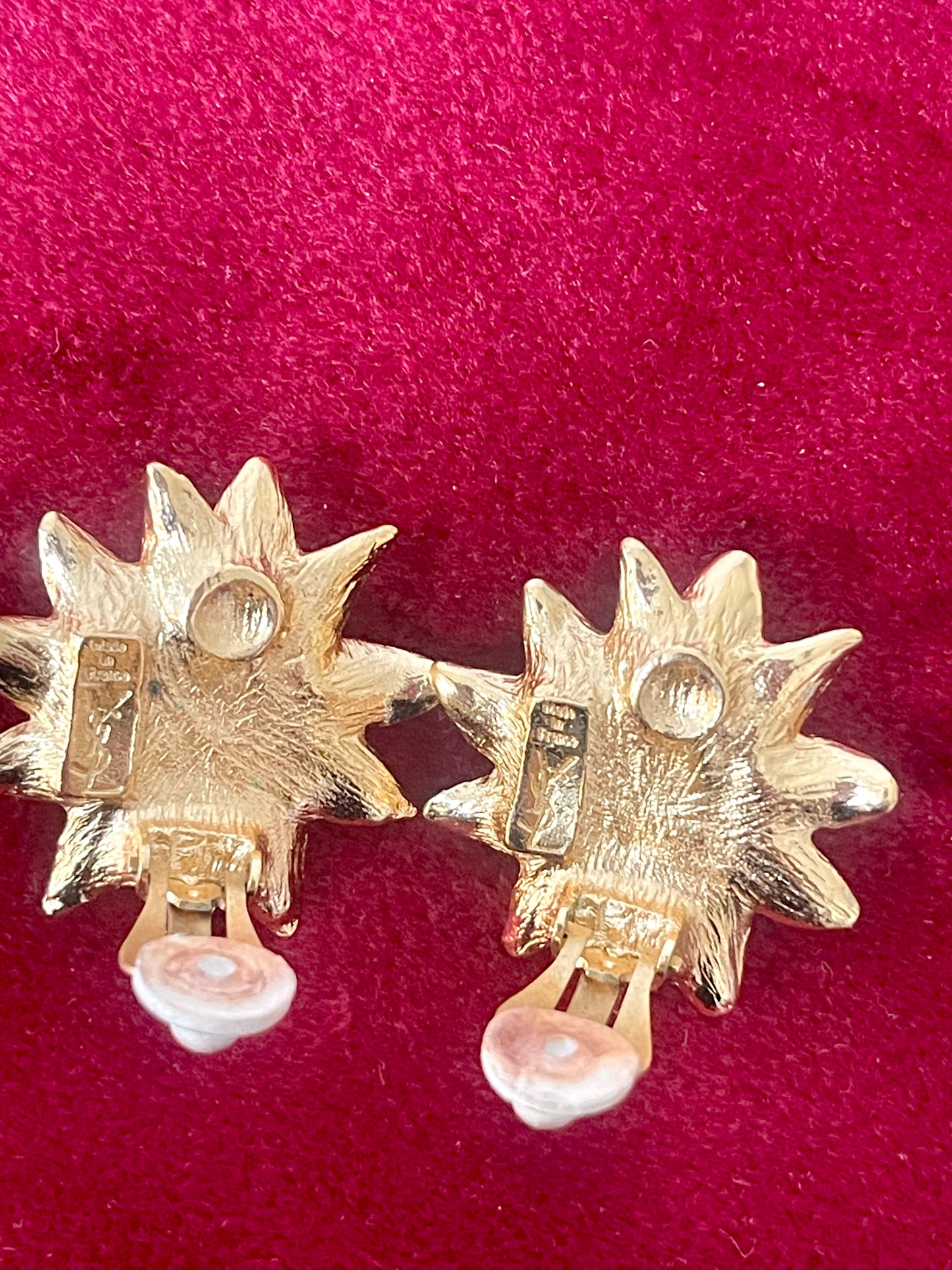 Backside view of Vintage Yves Saint Laurent gold-tone floral earrings with pearl center, signed YSL Made in France, 1980s designer jewelry.