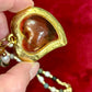 Close up view of Vintage Yves Saint Laurent Flower petal pendant with a fresh water pearl and precious stones necklace, 