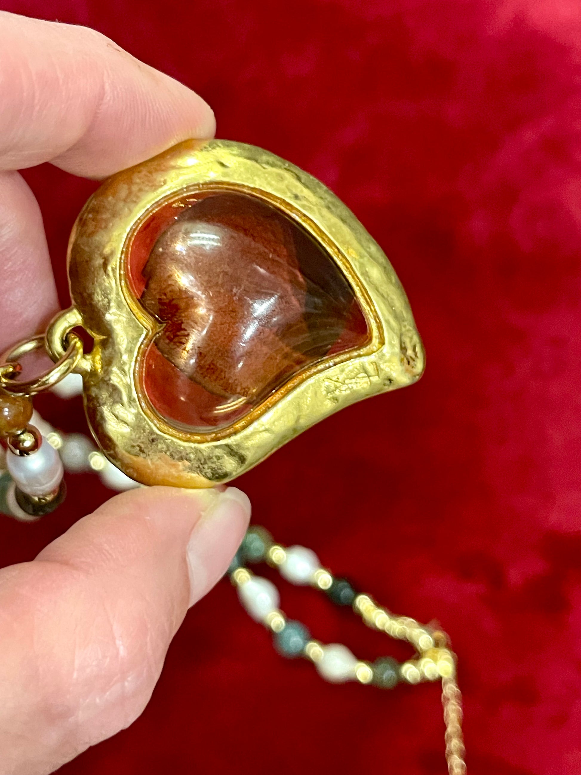 Close up view of Vintage Yves Saint Laurent Flower petal pendant with a fresh water pearl and precious stones necklace, 