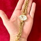 Vintage Yves Saint Laurent crystal chain bracelet signed YSL Made in France Placed in hand with a red background 