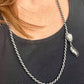 Different style worn by model Vintage Trifari silver-tone rope necklace with black cord featuring an attached Christian Dior crystal pendant 