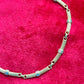 Vintage Christian Dior two-tone necklace with ribbed accents displayed on a red velvet background