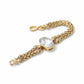 Yves Saint Laurent gold chain bracelet with a clear gemstone on a white background