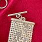 Close-up on signature of pixel metal mesh texture reflecting light of Vintage Paco Rabanne belt 