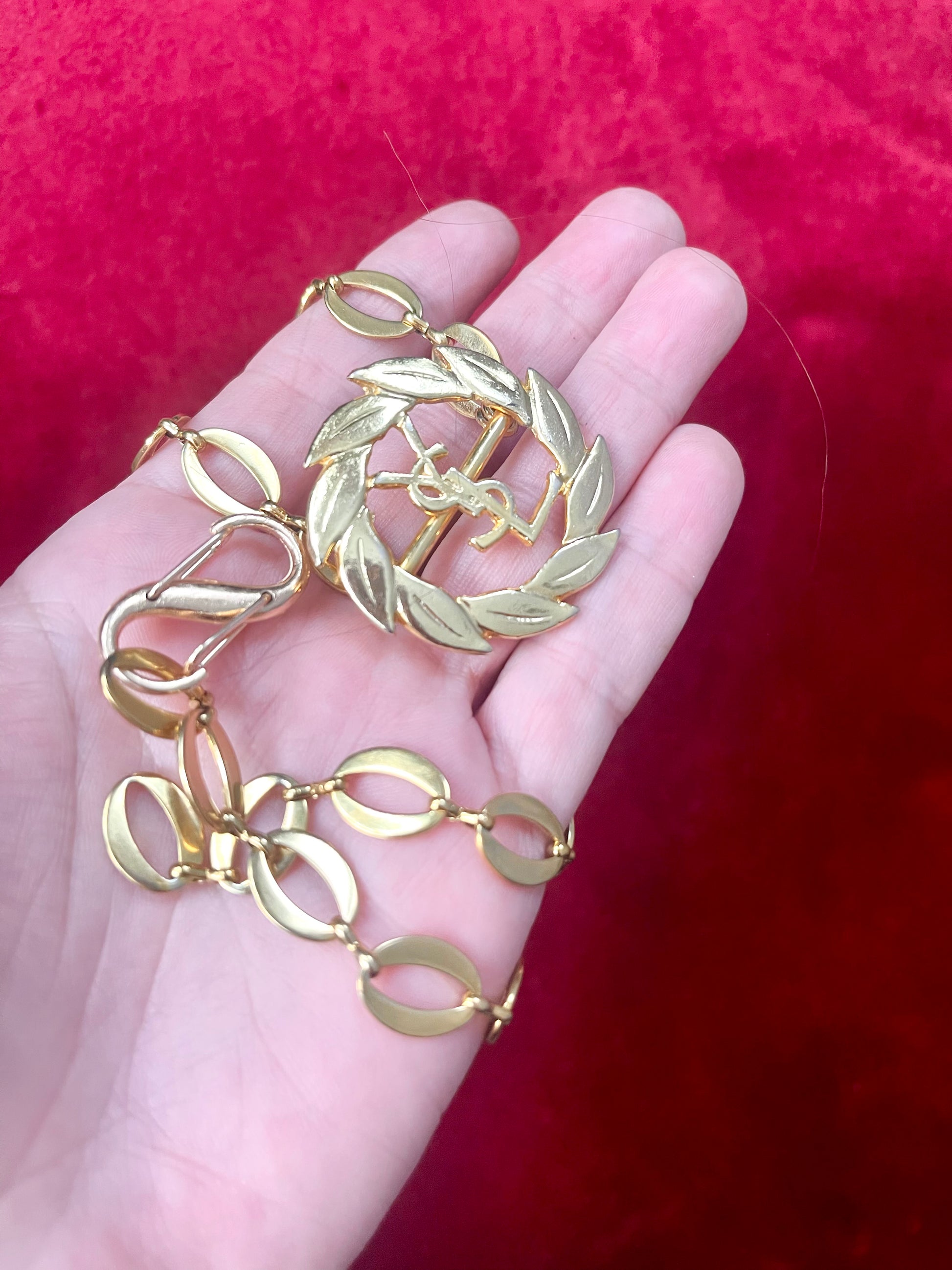 Layer on hand a refurbished vintage YSL laurel wreath pendant mounted on a gold-plated stainless steel necklace, with adjustable hoop links and a slightly lighter-toned closure.