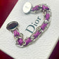 Purple braided Gourmet Dior bracelet with silver chain on a Dior branded box backside view