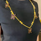 Vintage 80s five Yves Saint Laurent Butterfly Enameled pendants mounted on a Nina Ricci gold necklace, displayed on a black background worn by model