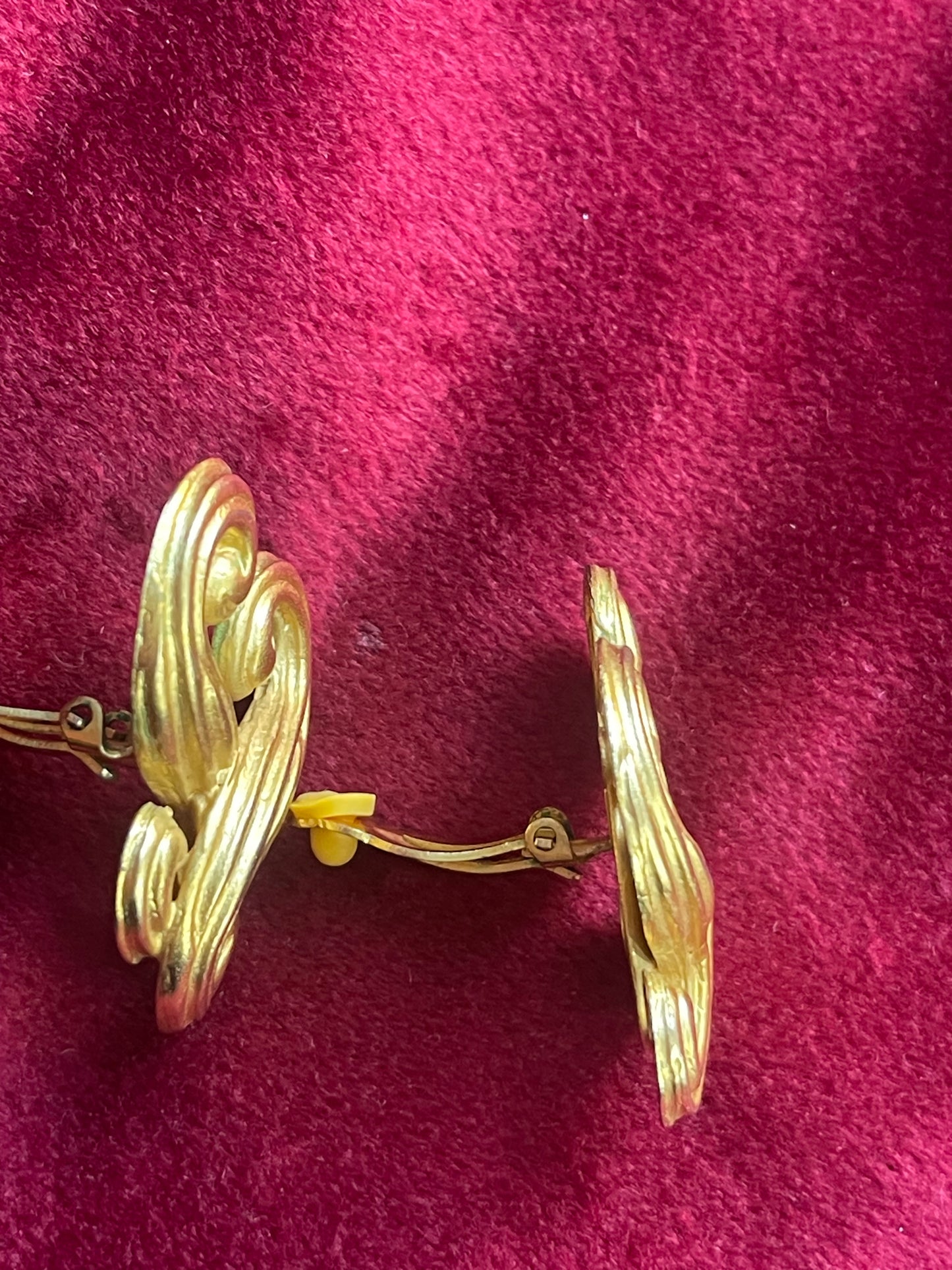 Side view of Pair of vintage Nina Ricci statement heart earrings with artistic swirling form