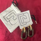 Paco Rabanne XL Link earrings in brown resin and gold metal, front view, 2025 collection, made in Italy Included pouch and tag card on red background 