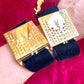 Side view of two Fashion Bracelet makeup Yves Saint Laurent vintage 2000 displayed with YSL pins on a red velvet background 
